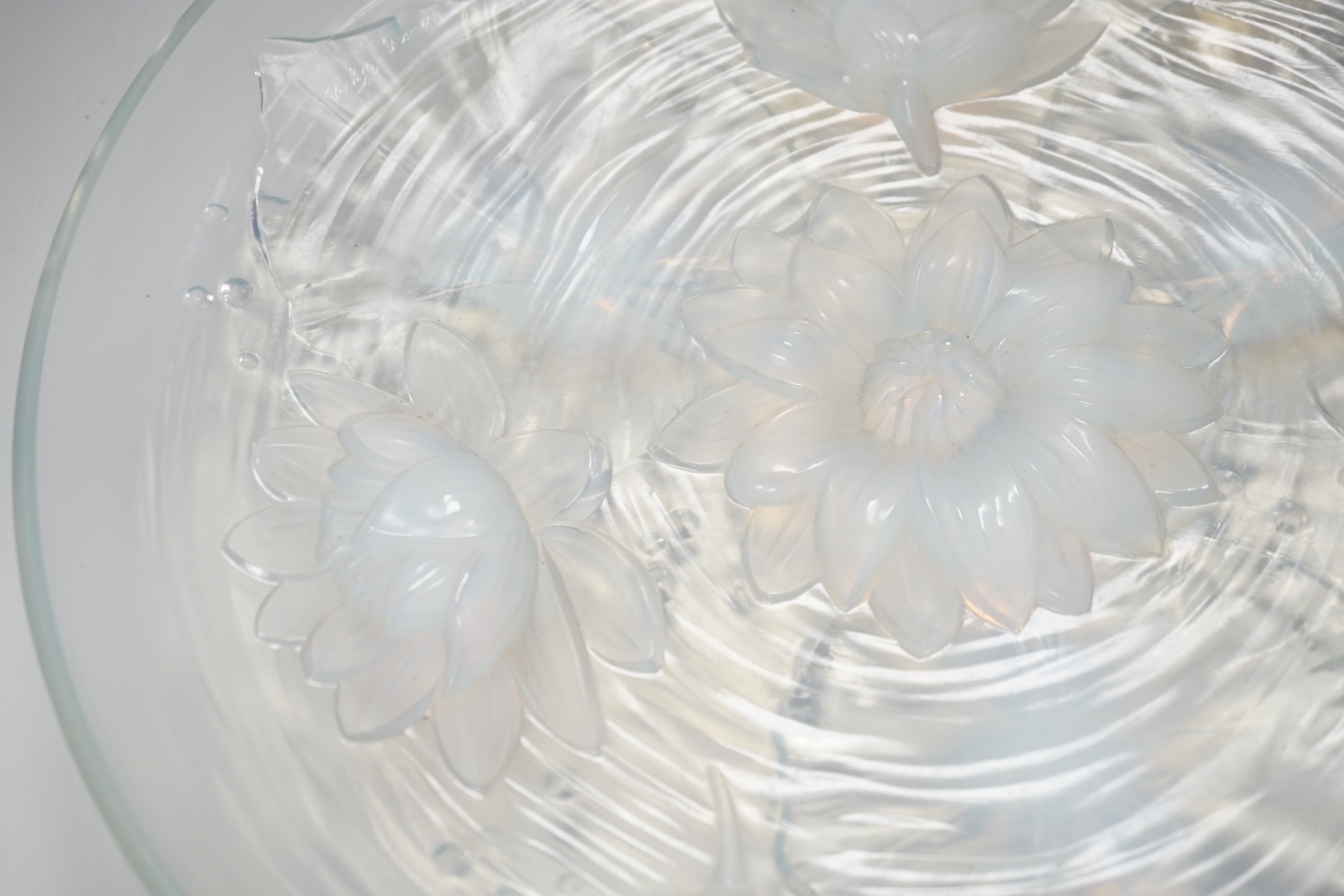 A Verlys opalescent glass dish with flower decoration. 35cm diameter